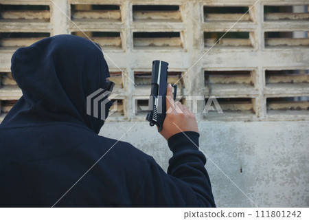 Terrorist war criminal men make a crime thief in black dress head shot. Bad anonymous soldier army with gun weapon in hand mafia attack. kidnap illegal bandit murderer. Criminal terrorist war concept 111801242