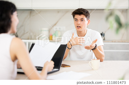 Girl manager tells guy client about specifics of design of microloan, about benefits and advantages. Girl manager tells guy client about specifics of design of microloan, about benefits and advantages. 111801473