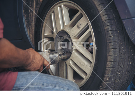 Close up Mechanic man hands repairing car auto repair shop uses jack change tyre. Man hands fixing Shock absorber machinery vehicle mechanical service. Vehicle Car overhaul maintenance engineer Close up Mechanic man hands repairing car auto repair shop uses jack change tyre. Man hands fixing Shock absorber machinery vehicle mechanical service. Vehicle Car overhaul maintenance engineer 111801911