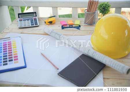 construction engineer office desk architect workplace. engineer drawing objects table with meter, blueprint, hard hat engineering stuff on desk. Designer Objects drafting workplace on wooden table. 111801930