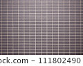 A wall of tiles arranged in an orderly manner 111802490