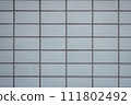 Retro wall lined with wavy tiles 111802492