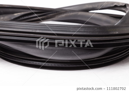 Rolled up black rubber sealant for elements of the car body, doors or trunk, for noise insulation, thermal and sound, preventing heat loss in the car interior. Sealing gasket for repair in a workshop. Rolled up black rubber sealant for elements of the car body, doors or trunk, for noise insulation, thermal and sound, preventing heat loss in the car interior. Sealing gasket for repair in a workshop. 111802702