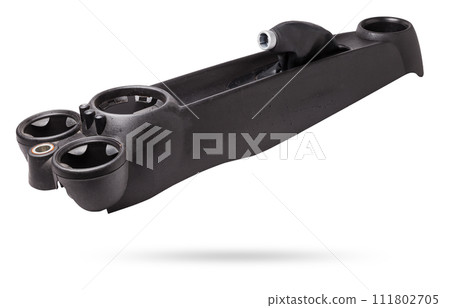 Dismantled car center console on a white isolated background in a photo studio - gray plastic panel with metal elements, spare part for sale and installation in a auto service center. Dismantled car center console on a white isolated background in a photo studio - gray plastic panel with metal elements, spare part for sale and installation in a auto service center. 111802705