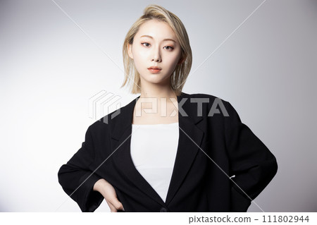 Cool portrait of young high-toned woman wearing black jacket Cool portrait of young high-toned woman wearing black jacket 111802944