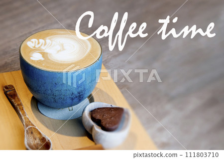 Hot Cappuccino In Cup On Wooden Table With Copy-space. The Latte Art On coffee background. coffee time banner. Hot Cappuccino In Cup On Wooden Table With Copy-space. The Latte Art On coffee background. coffee time banner. 111803710