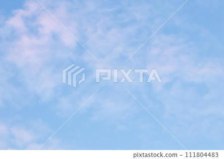 Background of blue sky with pale pink clouds at sunset Background of blue sky with pale pink clouds at sunset 111804483