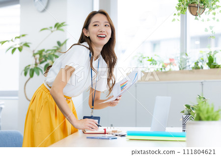 Young woman working in a business office Young woman working in a business office 111804621