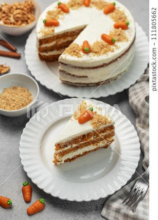 Homemade carrot cake made with walnuts, iced with cream cheese. Sweet dessert. Homemade carrot cake made with walnuts, iced with cream cheese. Sweet dessert. 111805662