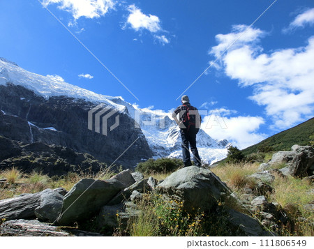 Rear view of a male climber looking at the peak of Rob Roy Glacier, New Zealand 111806549