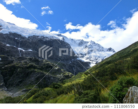 New Zealand Rob Roy Glacier, contrast of greenery, rocks, snow, sky and clouds 111806550