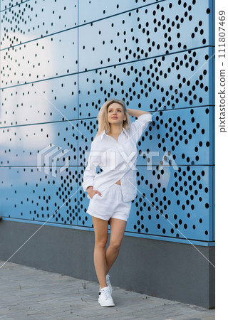 Happy young woman walking on city streets 111807469