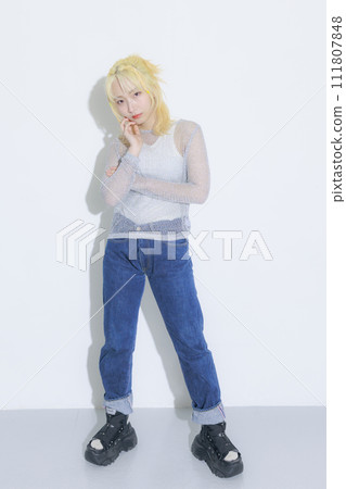 Blonde young woman wearing street fashion 111807848