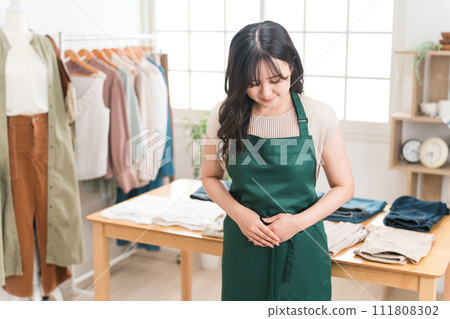 Shop clerks and staff at apparel shops, clothing stores, and jeans shops 111808302