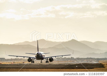 Sendai Airport at dusk, airplane taking off, Natori City, Miyagi Prefecture Sendai Airport at dusk, airplane taking off, Natori City, Miyagi Prefecture 111810397