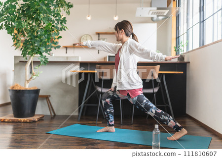 Asian woman doing yoga yoga at home using yoga mat Asian woman doing yoga yoga at home using yoga mat 111810607