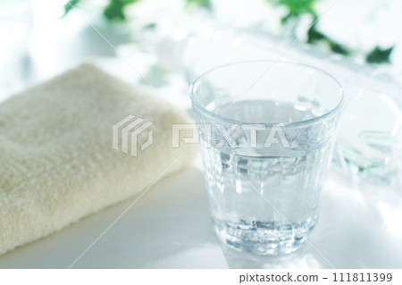 Glass of water, plastic bottle and towel Glass of water, plastic bottle and towel 111811399