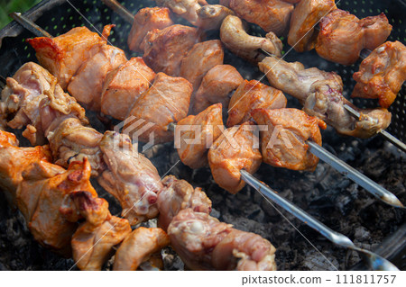 Chicken skewers on skewers in coals. 111811757