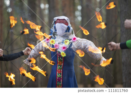 Burning straw stuffed carnival, a symbol of winter and death in Slavic mythology, pagan tradition.  111811760