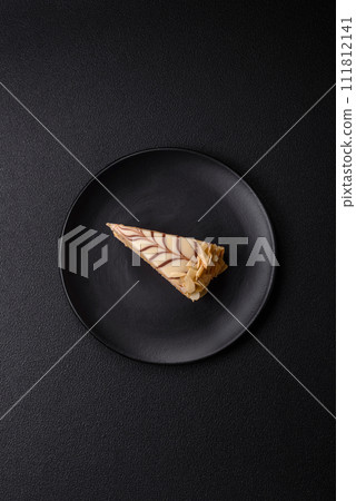 Piece of delicious sweet esterhazy cake with nuts and cream 111812141