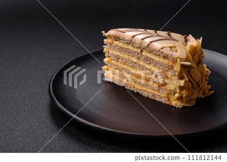 Piece of delicious sweet esterhazy cake with nuts and cream 111812144