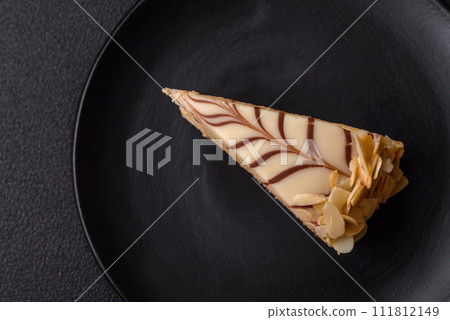 Piece of delicious sweet esterhazy cake with nuts and cream Piece of delicious sweet esterhazy cake with nuts and cream 111812149