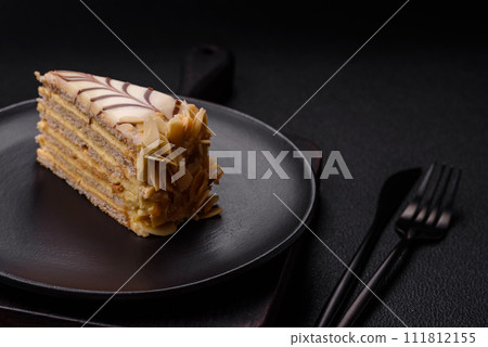 Piece of delicious sweet esterhazy cake with nuts and cream 111812155