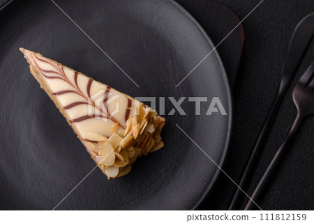 Piece of delicious sweet esterhazy cake with nuts and cream Piece of delicious sweet esterhazy cake with nuts and cream 111812159