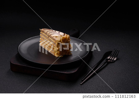 Piece of delicious sweet esterhazy cake with nuts and cream Piece of delicious sweet esterhazy cake with nuts and cream 111812163