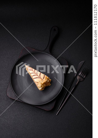 Piece of delicious sweet esterhazy cake with nuts and cream 111812170