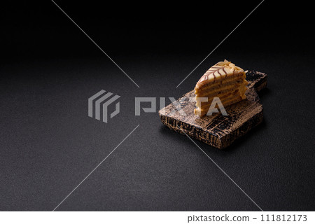 Piece of delicious sweet esterhazy cake with nuts and cream 111812173