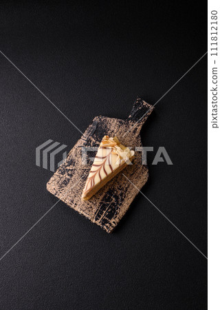 Piece of delicious sweet esterhazy cake with nuts and cream 111812180