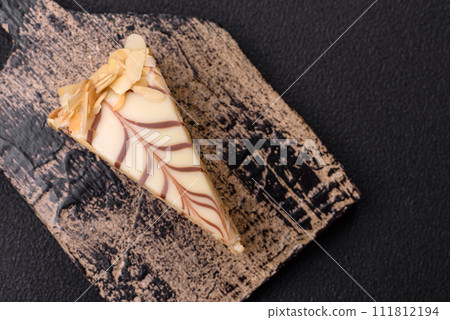 Piece of delicious sweet esterhazy cake with nuts and cream 111812194