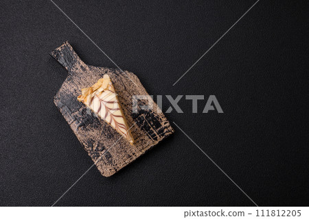 Piece of delicious sweet esterhazy cake with nuts and cream Piece of delicious sweet esterhazy cake with nuts and cream 111812205