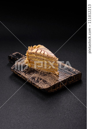 Piece of delicious sweet esterhazy cake with nuts and cream Piece of delicious sweet esterhazy cake with nuts and cream 111812213