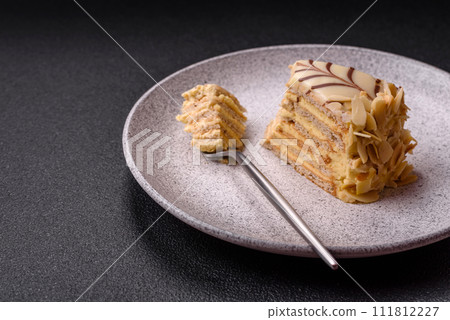Piece of delicious sweet esterhazy cake with nuts and cream Piece of delicious sweet esterhazy cake with nuts and cream 111812227