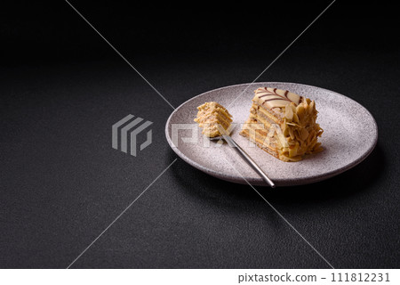 Piece of delicious sweet esterhazy cake with nuts and cream 111812231