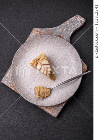 Piece of delicious sweet esterhazy cake with nuts and cream Piece of delicious sweet esterhazy cake with nuts and cream 111812241