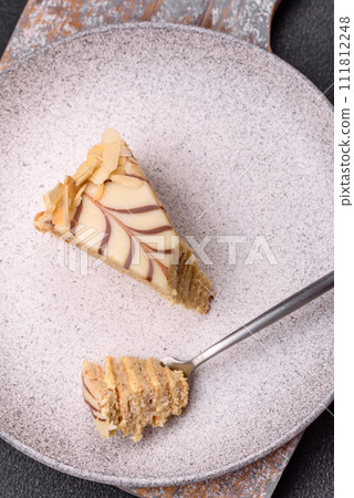 Piece of delicious sweet esterhazy cake with nuts and cream 111812248