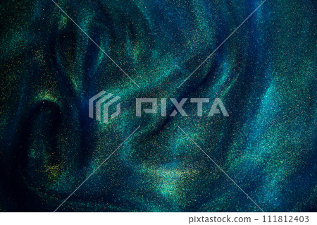 Bursting Gold Dust Particles in Blue Liquid. Abstract gold sparkling particles in blue fluid with green tints. Abstract fantasy background of shiny golden dust. Bursting Gold Dust Particles in Blue Liquid. Abstract gold sparkling particles in blue fluid with green tints. Abstract fantasy background of shiny golden dust. 111812403