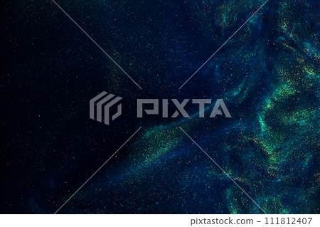 Floating Magic Gold Particles In Blue Fluid. Sparkling dust particles floating in a blue liquid with green tints, creating fantasy curved patterns and waves. Floating Magic Gold Particles In Blue Fluid. Sparkling dust particles floating in a blue liquid with green tints, creating fantasy curved patterns and waves. 111812407