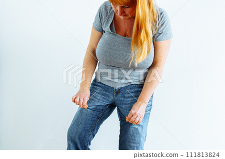 Gynecologic problems, urinary incontinence, female health. Woman showing off wet jeans 111813824