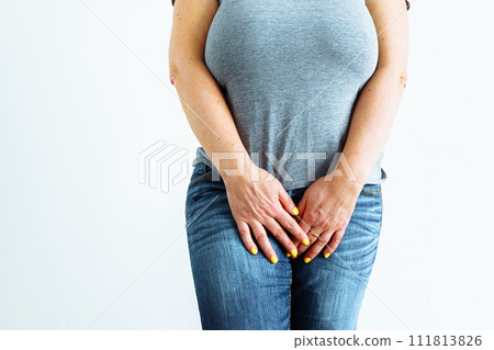 Gynecologic problems, urinary incontinence, female health. Woman holds hands between her legs Gynecologic problems, urinary incontinence, female health. Woman holds hands between her legs 111813826
