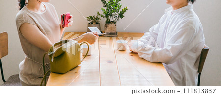 A woman (no face) who hands over her payment at a cafe/coffee shop and tries to leave A woman (no face) who hands over her payment at a cafe/coffee shop and tries to leave 111813837
