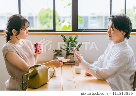 A man who declines/rejects payment from a woman when paying at a cafe/restaurant/eating out A man who declines/rejects payment from a woman when paying at a cafe/restaurant/eating out 111813839