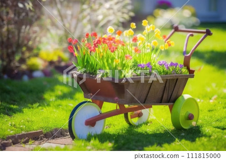 Wheelbarrow with flowers and gardening equipment 111815000