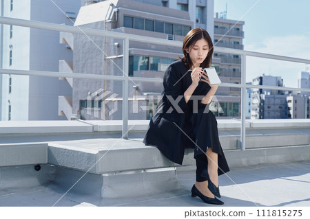 Business woman taking notes on the rooftop Business woman taking notes on the rooftop 111815275