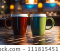 Red and green coffee cups are positioned close to one another on a tabletop against a hazy backdrop. 111815451