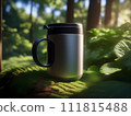 a coffee cup lit by the sun's rays as it filters through the foliage in the forest's shade. 111815488