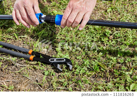 Connecting HDPE pipes with compression fitting coupling when installing irrigation water supply. Connecting HDPE pipes with compression fitting coupling when installing irrigation water supply. 111816263